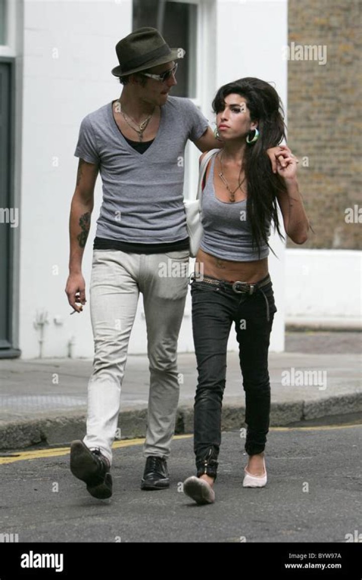 Amy Winehouse and husband Blake Fielder Civil getting on a train at