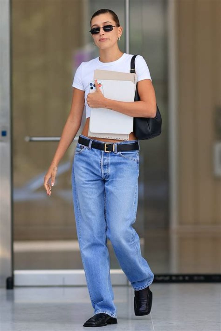 hailey bieber looks fit in a black crop top and shorts after finishing